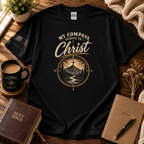 My Compass Points to Christ Christian T-shirt hero image in black with Bible and devotional