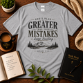 Sport Grey God’s Plan Is Greater Than Your Mistakes Christian T-Shirt displayed with Bible, devotional, mug, and greenery
